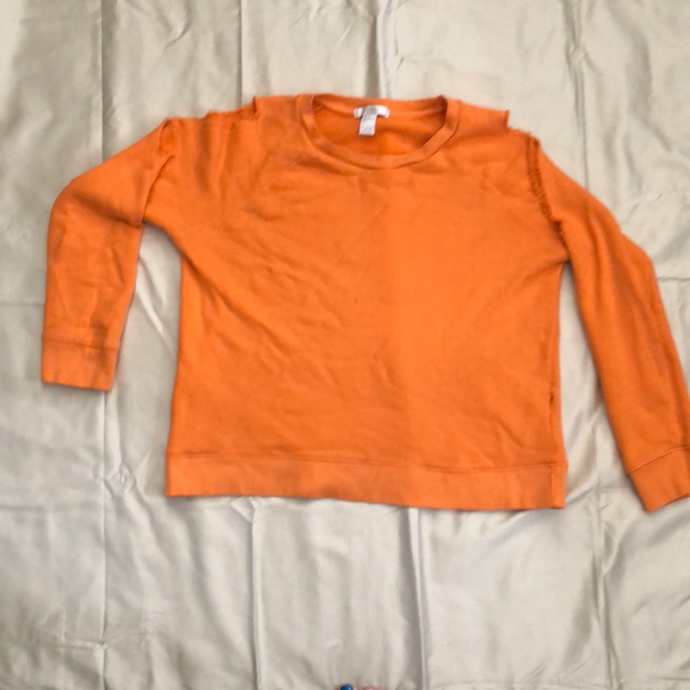 Orange cropped sweater with shoulder cutouts